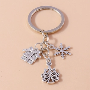 Detail view of vintage silver Christmas keychains with snowflake, tree and gift box charms