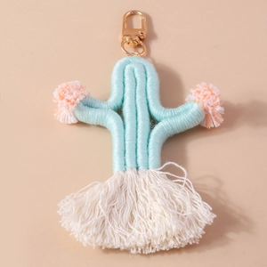 Detail of woven cactus keychain with soft pom poms and a golden lobster clasp