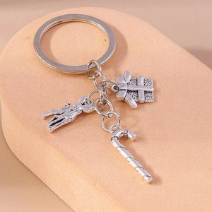 Detailed close-up of silver Christmas keychain with donkey gift box and candy cane charms