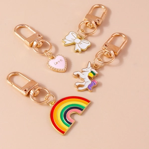 Close-up of golden keychain set with colorful rainbow, unicorn, and heart charms