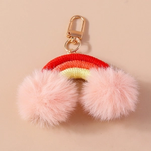 Handmade woven rainbow keychain with large pink pom poms and gold lobster clasp