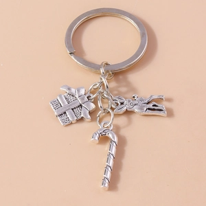 Detailed view of alloy Christmas keychain featuring gift box, candy cane and animal charms