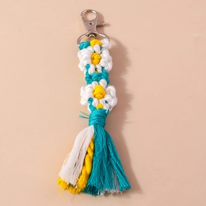 Detail of handmade crochet daisy keychain with colorful cotton tassels and silver lobster clasp
