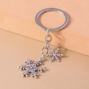 Detailed view of antique silver snowflake pendants on a creative metal keychain accessory