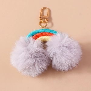 Rainbow keychain with purple pom-poms and colorful woven rope with gold metal clasp