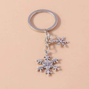 Close-up of vintage silver alloy snowflake keychains with intricate cutout details