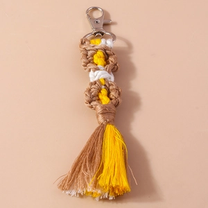 Detailed view of handmade bohemian tassel keychain with woven floral patterns and silver clasp