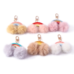 Handmade woven rainbow keychain set with plush pompoms and gold lobster clasp