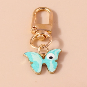 Vue détaillée du porte-clés papillon en marbre bleu clair avec fermoir en métal doré