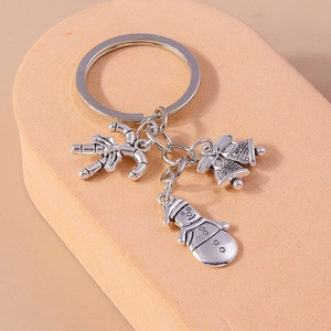 Detailed view of silver Christmas key ring with candy cane, bells and snowman charms