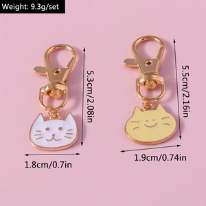 Detailed view of cat keychain with size measurements and golden lobster clasp hardware