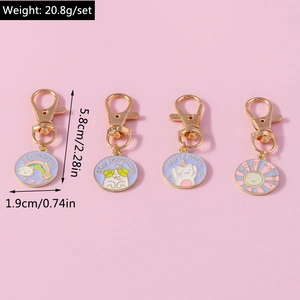 Detailed view of four colorful enamel sun and pet pendants for keychains and accessories