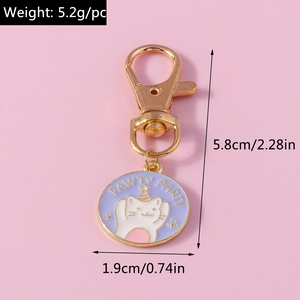 Detailed macro view of enamel cat keychain with PAWTY PARTY text and golden clasp