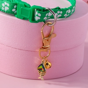 Green nylon pet collar with white paw prints, fishbone pendant and golden bell