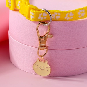 Yellow pet collar strap with white cat paw prints and a cute cat face enamel pendant