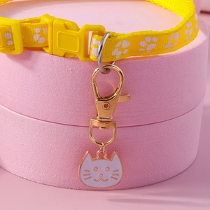 Adjustable yellow nylon pet collar with white paw prints and cute cat enamel pendant
