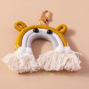 Handmade woven rainbow bear keychain with white cotton tassels and gold metal lobster clasp