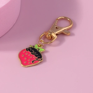 Cute strawberry cat keychain with a black cartoon kitten on pink fruit alloy pendant