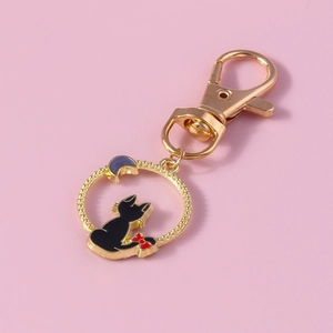 Porte-clés doré avec pendentif ajouré, chat noir et breloques en forme de lune violette