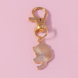 Cute golden cat pendant keychain with heart-shaped design and smooth metal finish