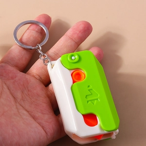 Close-up of a 3D gravity carrot knife toy keychain made of colorful ABS plastic material