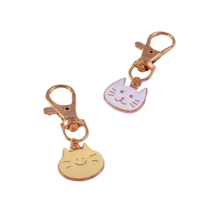 Set of two cute cartoon cat head keychains in white and yellow enamel finish