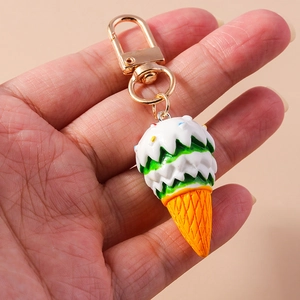 Detail of cute multilayer ice cream keychain with colorful sprinkles and golden metal clasp