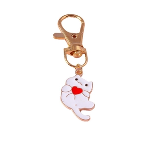 Cute white enamel cartoon cat keychain holding a red heart with rose gold lobster clasp