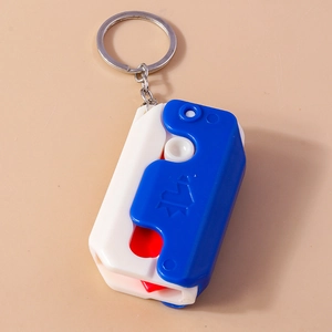 Detail view of foldable utility knife keychain with blue, white, and red plastic casing
