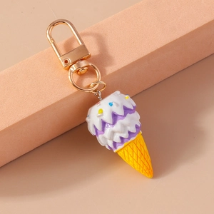 Close-up of cute ice cream keychain with golden lobster clasp and colorful resin charm