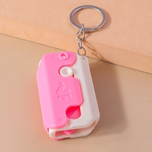 Detail of a pink crown mini carrot knife keychain with smooth plastic and metal ring