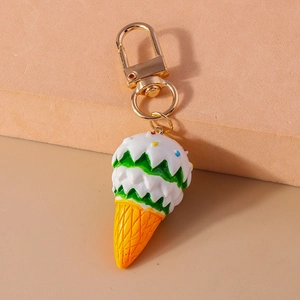 Close-up of cute ice cream keychain with colorful sprinkles and a gold lobster clasp