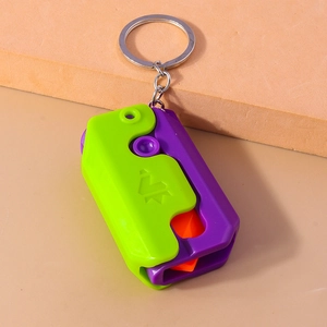 Detail of colorful plastic gravity knife keychain with metal ring and engraved logo