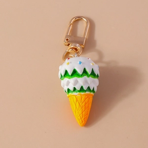 Close-up of cute ice cream keychain with colorful sprinkles and golden lobster clasp