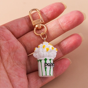 Creative popcorn keychain featuring a realistic striped cup and gold lobster clasp