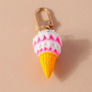 Cute cartoon ice cream keychain with pink and white scoops and golden metal clasp