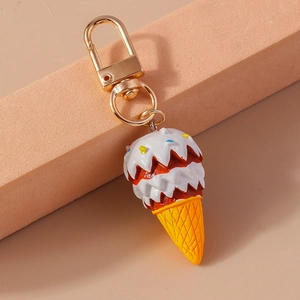 Macro detail of artificial ice cream keychain with colorful syrup and golden metal clasp