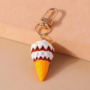Detailed close-up of a double-scoop ice cream keychain with a textured orange cone