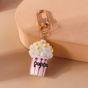 Detailed close-up of a realistic popcorn bucket keychain with a gold metal clasp
