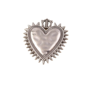 Vintage silver heart pendant with crown detail and sunburst texture on white background