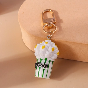 Detailed close-up of a cute popcorn keychain featuring a golden metal lobster clasp