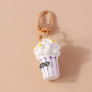 Detailed view of creative popcorn keychain with purple striped bucket and golden metal clasp