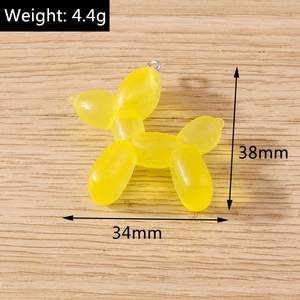 Detail view of yellow translucent resin balloon dog pendant with 34mm by 38mm dimensions