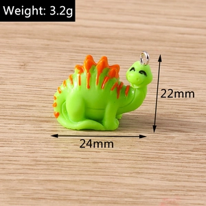 Detail view of a green dinosaur charm with silver ring showing dimensions 24x22mm and 3.2g
