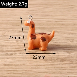 Macro detail of cute orange dinosaur pendant with dimensions 27mm height and 2.7g weight