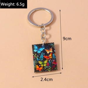 Detailed view of colorful oil painting butterfly keychain showing 9cm length and dimensions