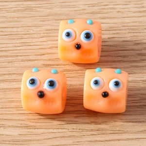 Five-pack of cute orange resin monster beads with blue eyes for DIY cartoon jewelry making