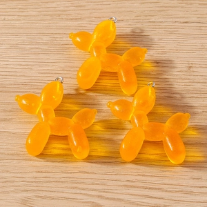 Three translucent orange resin balloon dog charms with silver rings for DIY jewelry making
