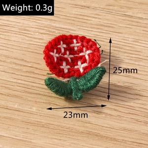 Macro detail of handmade crochet flower pendant with size markings on wood background