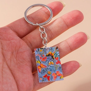 Detail of keychain showing colorful butterfly floral patterns on a scalloped acrylic charm